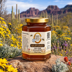 Jar of Clark Bees Wildflower Honey in a desert setting with cacti and flowers.