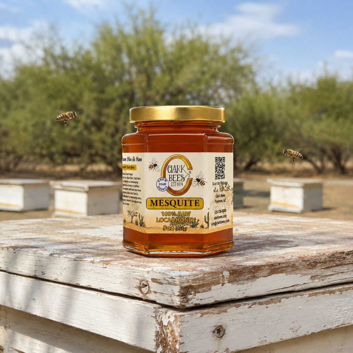 Jar of Oark Bees Mesquite honey on a wooden surface with bees and beehives in the background.